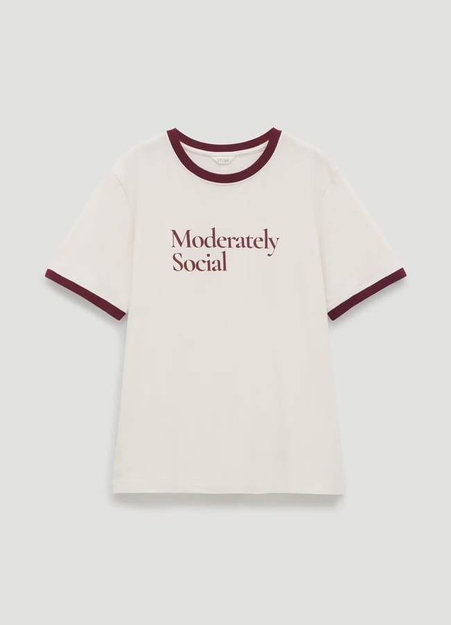 White T-shirt with maroon collar and sleeve trim, featuring the text Moderately Social printed in maroon on the front, centred against a plain background—perfect for anyone who loves cool slogan tees.