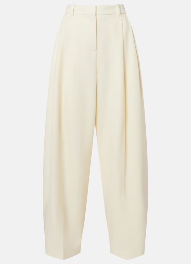 High-waisted, wide-leg cream trousers with pleats down the front, belt loops, and a tailored fit—perfect for effortless style during our summer sale.