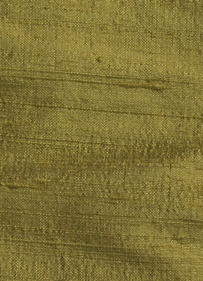 Close-up of olive green raw silk fabric with a slightly rough texture and subtle horizontal slubs, reflecting the chartreuse colour trend.