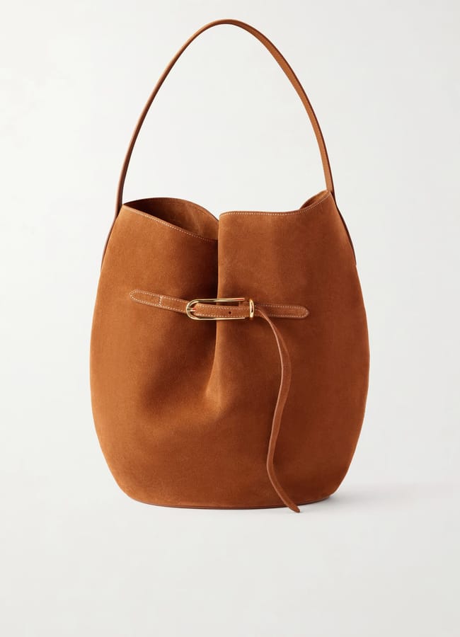 Brown suede hobo bag with a single top handle and a decorative leather strap with a gold buckle on the front, set against a plain white background—perfect for elevating your look during our summer sale.
