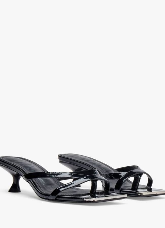 A pair of black, open-toe heeled sandals with thin straps and low kitten heels, displayed against a plain white background—an effortlessly chic choice to elevate your oversized shirt outfit ideas.
