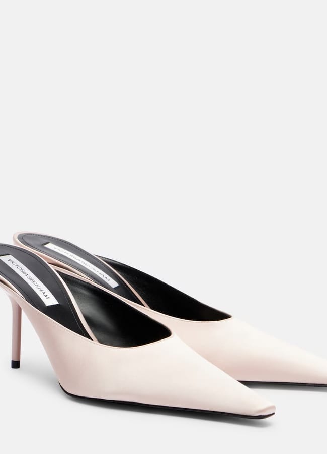 A pair of pale pink pointed-toe mule heels with slender high heels and black insoles, displayed against a plain white background—perfect for adding elegance to your look during the summer sale.