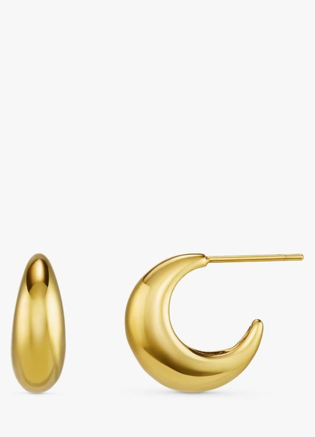 A pair of gold earrings: one is a smooth, oval teardrop shape, and the other is a chunky, crescent moon hoop with a visible post for piercing. Both have a shiny, polished finish—perfect for adding a chic touch to your oversized shirt outfit ideas.