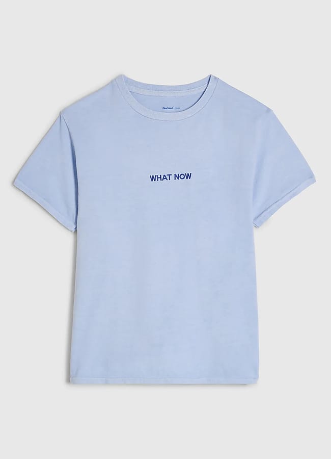 baby blue tshirt with ;what now' embroidered text