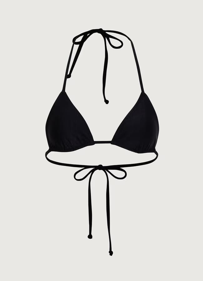 A black triangle bikini top with thin straps that tie at the neck and back, reminiscent of styles often spotted on celebrity couples on holiday, displayed on a plain light background.