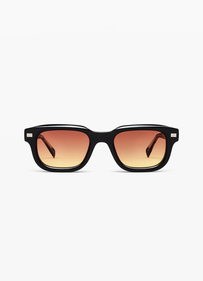 Black rectangular sunglasses with thick frames and gradient lenses that fade from dark red at the top to light yellow at the bottom. These stylish shades—perfect for recreating the effortless look of celebrity couples on holiday—are shown facing forwards on a white background.