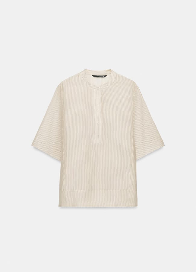 Beige, short-sleeved shirt with a subtle vertical stripe pattern, a round neckline, and a partial button placket on the front. The shirt has a loose, boxy fit and is displayed against a plain white background—a versatile piece that’s new in at Zara.