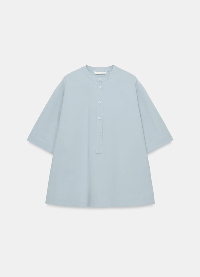 Light blue, loose-fitting, short-sleeved tunic with a round collar and partial front button placket, newly in at Zara and displayed on a plain white background.