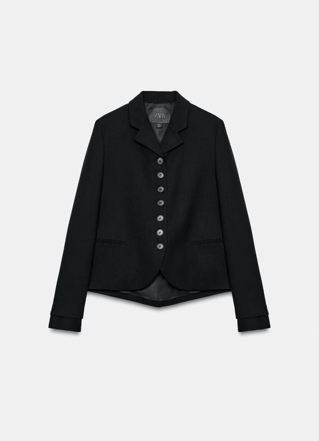 New in at Zara, this black tailored blazer features a notched lapel, long sleeves, and eight buttons down the front, displayed against a plain white background.