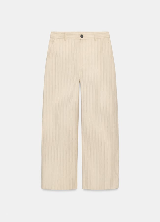 Wide-leg, high-waisted beige trousers with subtle vertical pinstripes, belt loops, a front button fastening, and side pockets—new in at Zara—displayed against a plain white background.