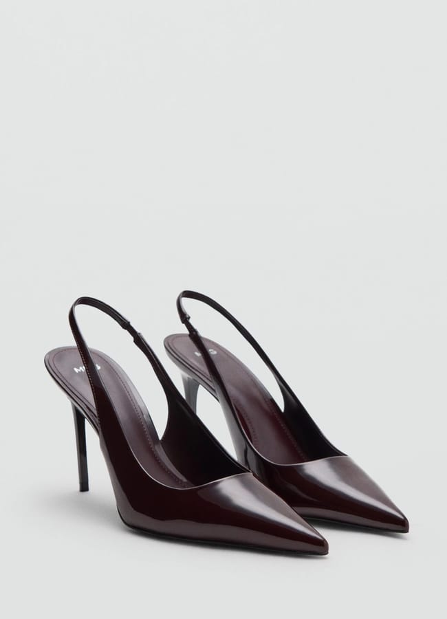 A pair of dark burgundy slingback high-heeled shoes with pointed toes, displayed on a light grey background—these sexy heels add irresistible allure to any outfit.