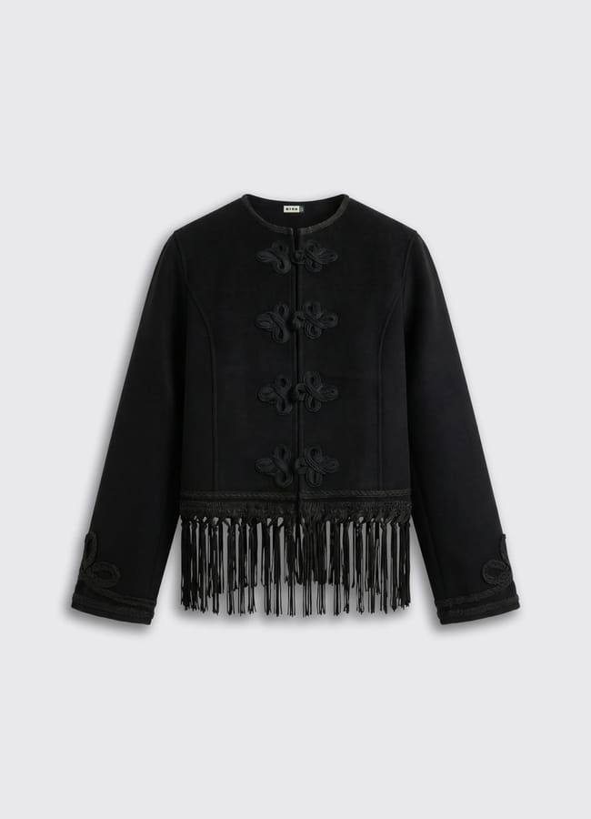 A black long-sleeve jacket with decorative knots on the front and black fringe along the bottom hem, displayed on a plain light grey background—perfect for those seeking stylish lightweight jackets with unique detailing.