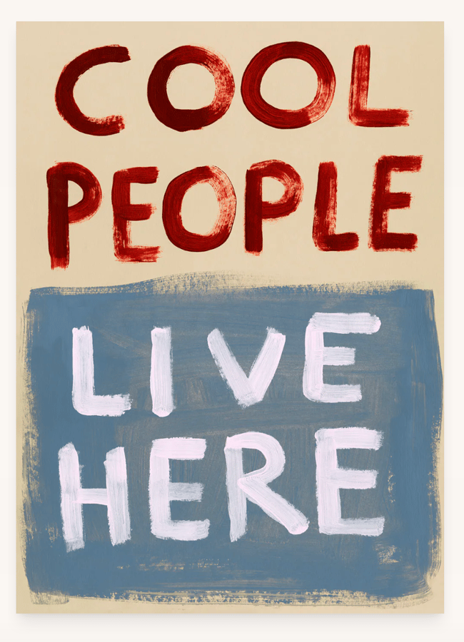 A painted sign with the words COOL PEOPLE in red on a beige background and LIVE HERE in white on a blue background showcases unexpected colour combinations that reflect current colour trends.