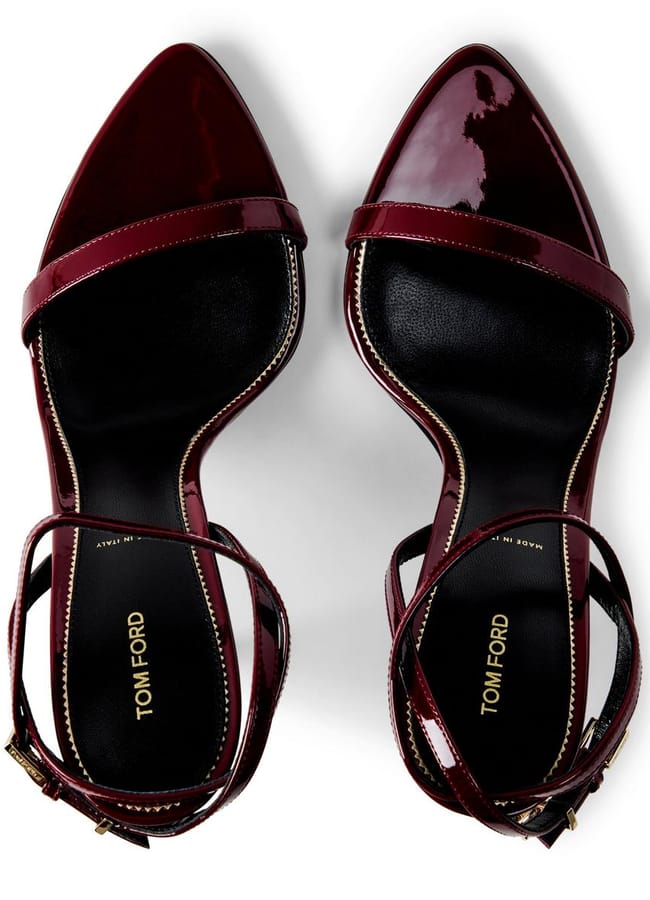 A pair of sexy heels—burgundy patent leather Tom Ford high-heeled sandals with ankle straps—pictured from above on a white background.