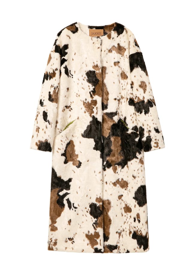 Jakke knee-length coat in a faux fur cow print from this Black-owned fashion brand, featuring a brown label at the collar.