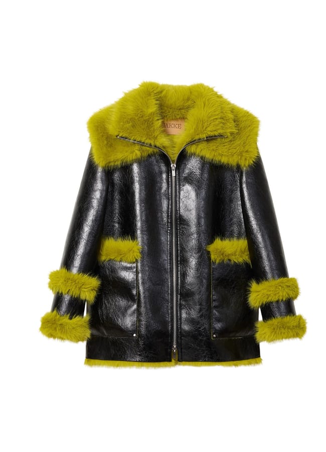 Black jacket from a Black-owned fashion brand, featuring a lime green faux fur collar, hem, and cuffs.