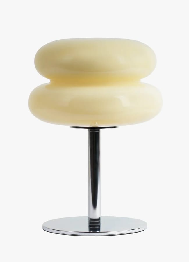 A cream-coloured, double-tiered mushroom-shaped lamp on a chrome pedestal base, perfect for listening room interior ideas.