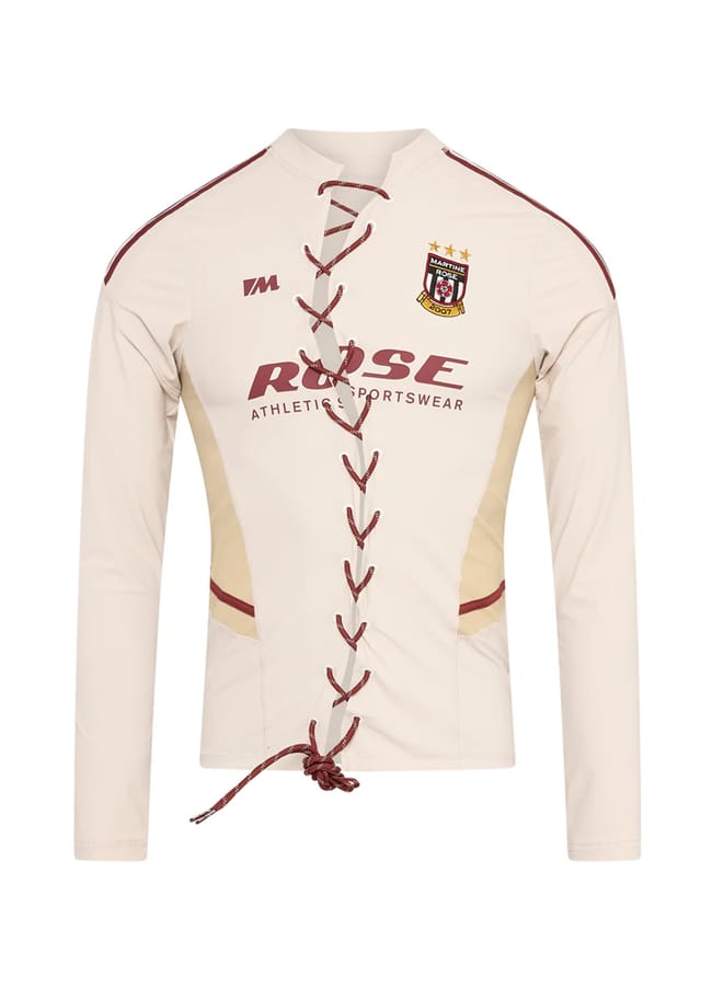 Cream-coloured long-sleeve athletic shirt from a black-owned fashion brand, featuring a lace-up front, maroon trim, and the Martine Rose logo on the chest.