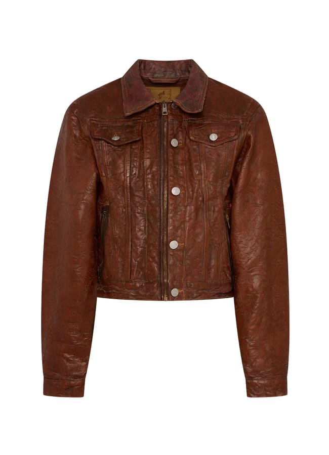 Brown leather jacket from a black-owned fashion brand, featuring a collared neckline, a front zip, and buttoned chest pockets.