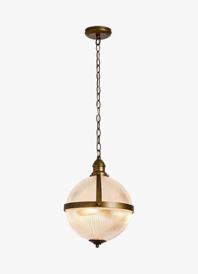 A round, ribbed glass pendant light by Rockett St George with bronze fittings hanging from a chain.