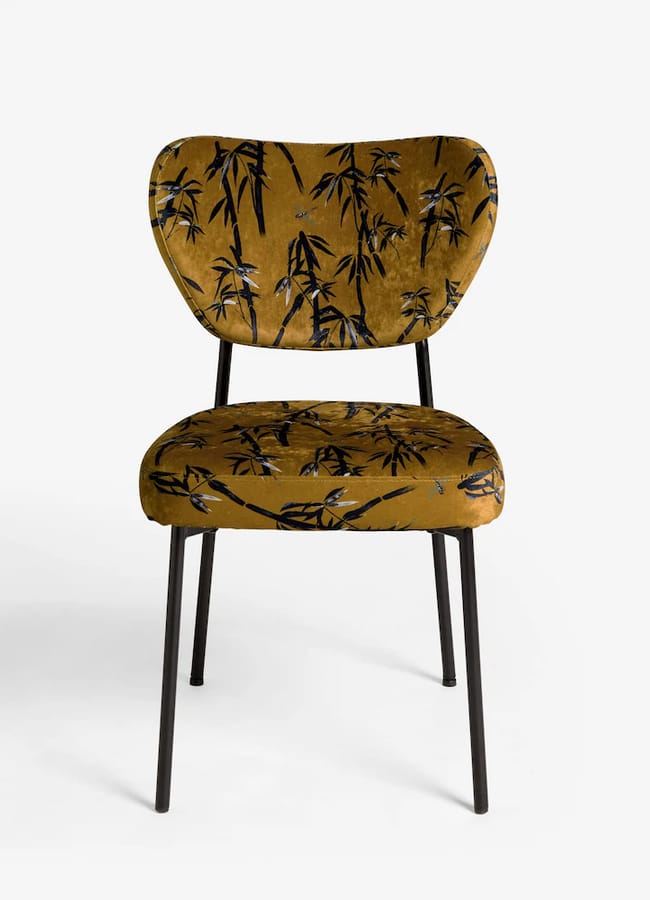 Mustard yellow Rockett St George dining chair featuring black bamboo print upholstery and thin black metal legs.