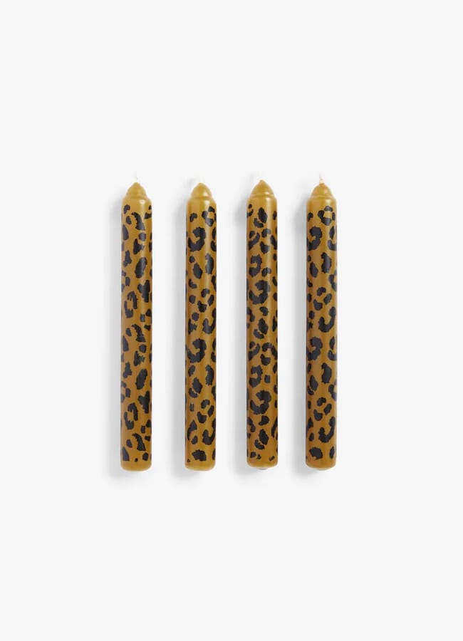 Four Rockett St George taper candles featuring a brown and black leopard print pattern.