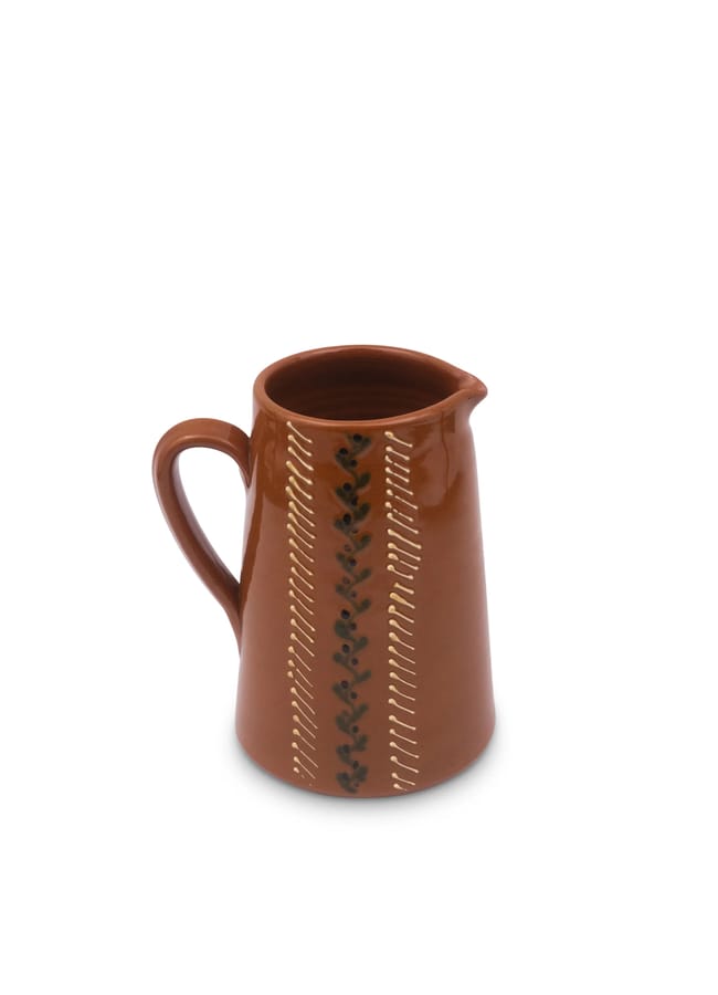 Brown ceramic jug with a handle and a vertical decorative pattern of dots and lines, perfect for autumn tablescape ideas.