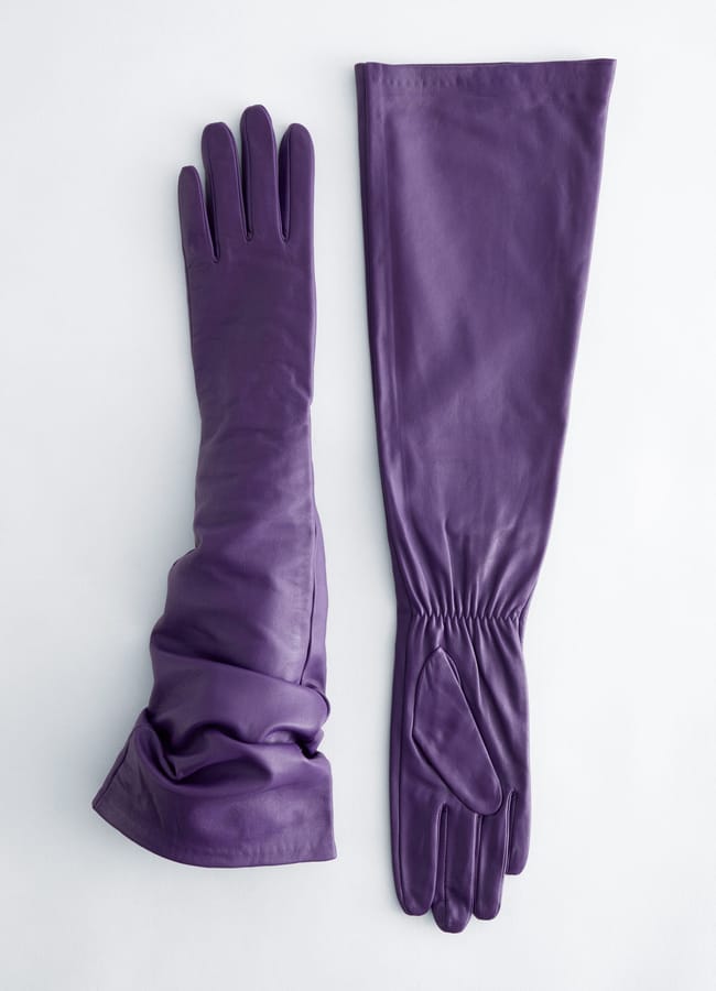 A pair of purple leather opera gloves laid flat.