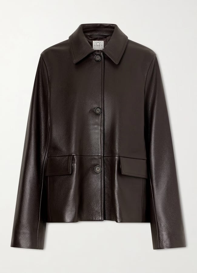 Dark brown leather jacket with a pointed collar, button front, and two flap pockets, representing one of the best women’s leather jackets.