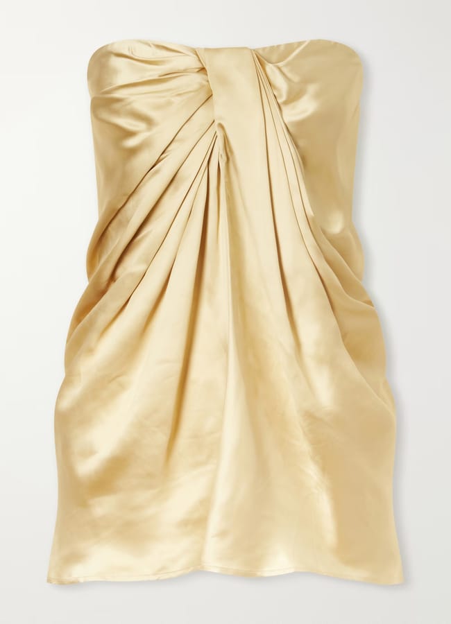Champagne-coloured strapless mini dress from a Black-owned fashion brand, featuring a draped, knotted bodice.