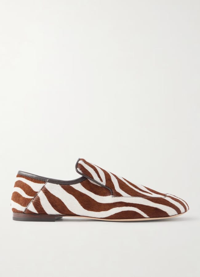A brown and white zebra print flat loafer from a British fashion brand.