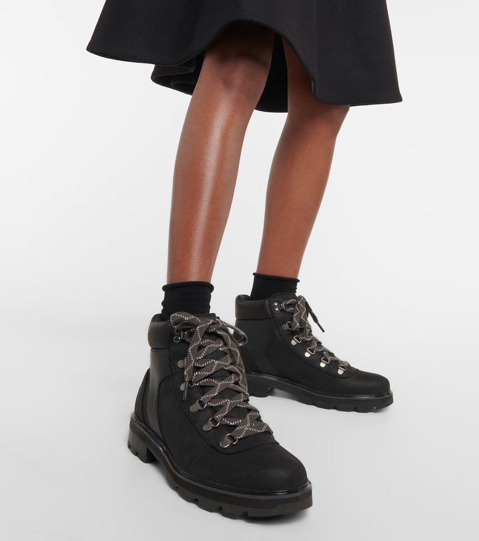 model's legs wearing black hiking boots