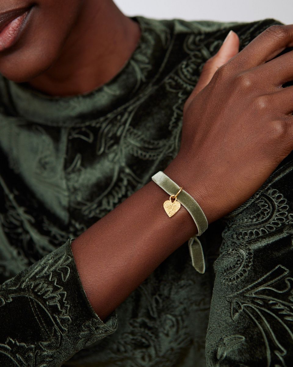 model's arm with Green Velvet Gold Plated Heart Charm Bracelet