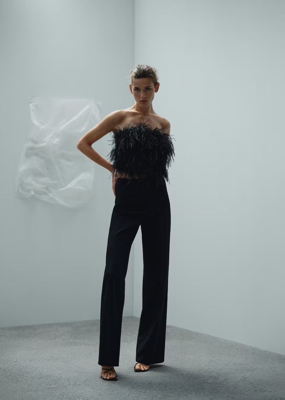 model wears feather bandeau top