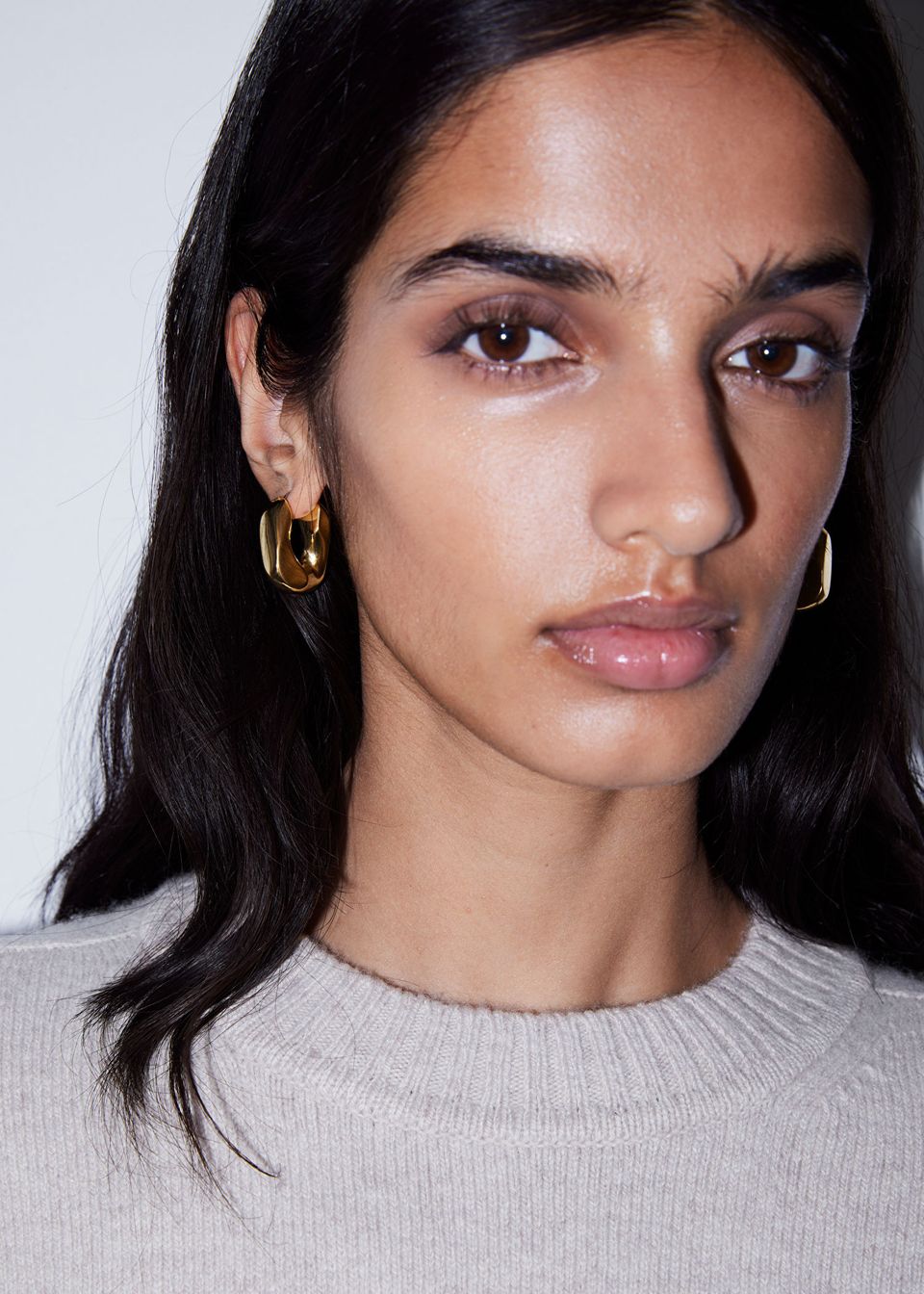 model wears Chunky Twist Hoop Earrings