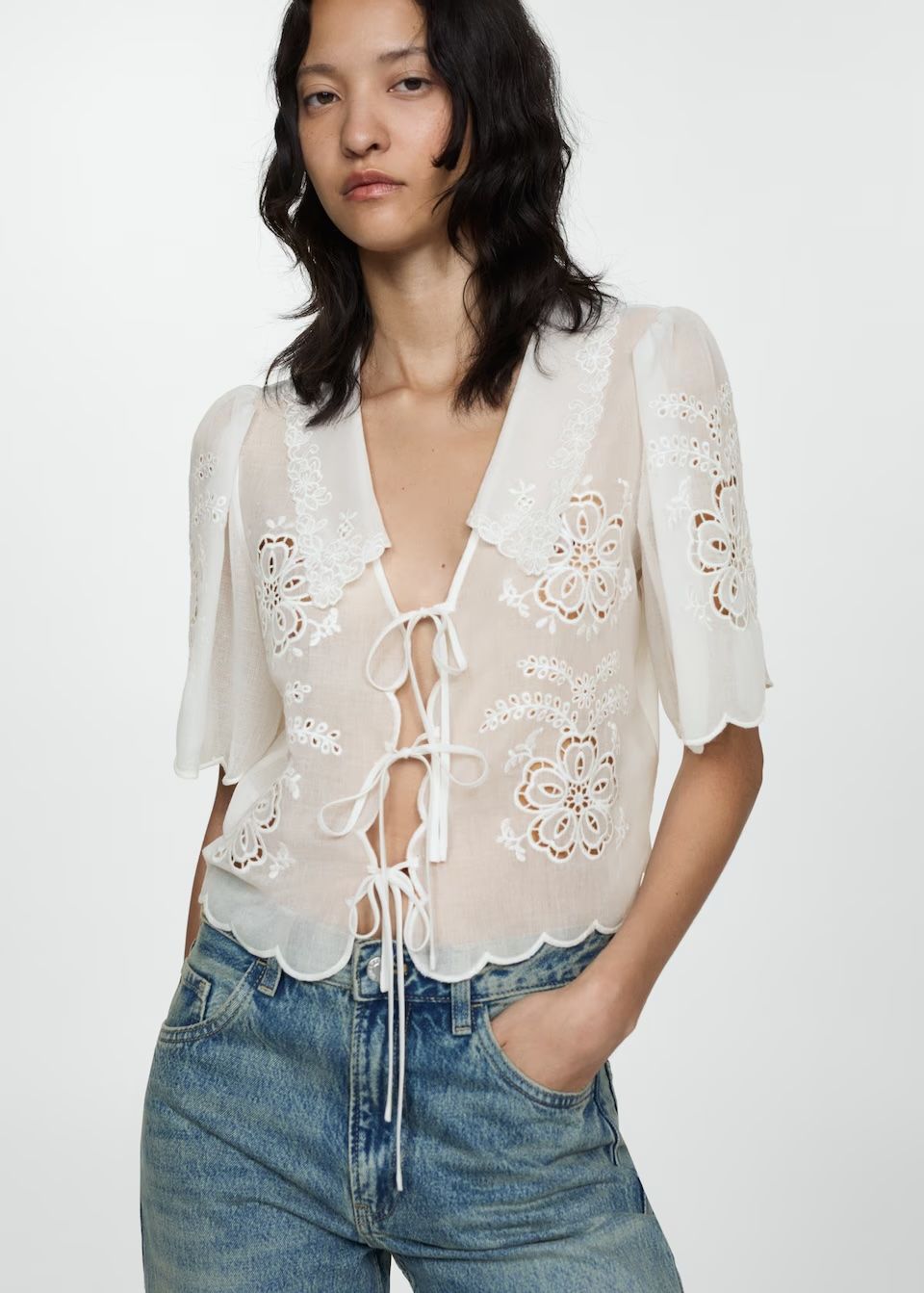 model wears white Embroidered blouse with bows