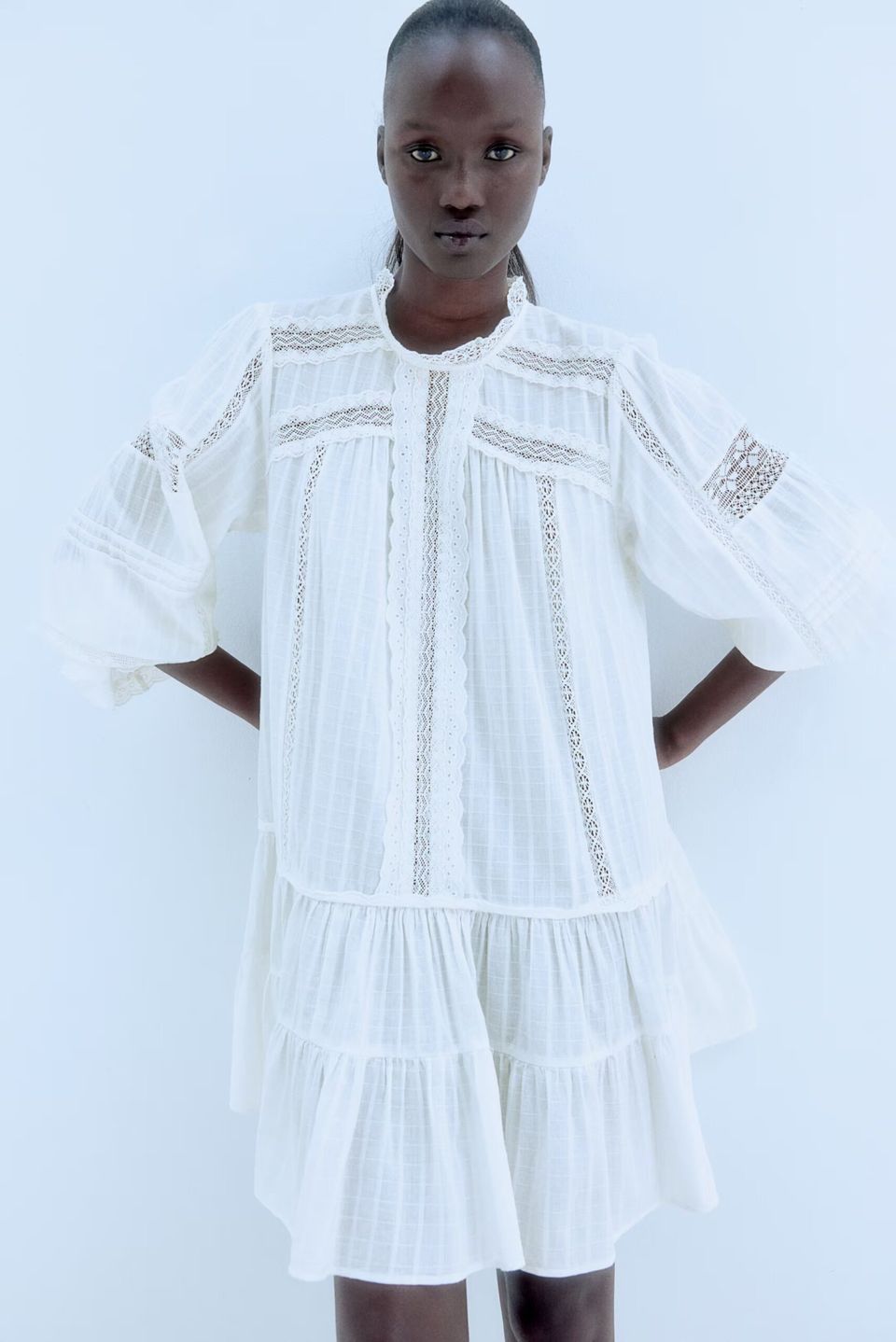 model wears H&M white lace dress