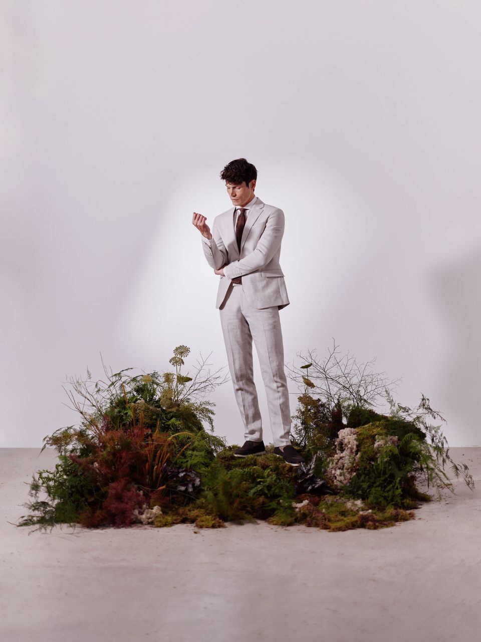 male model in suit on floral display