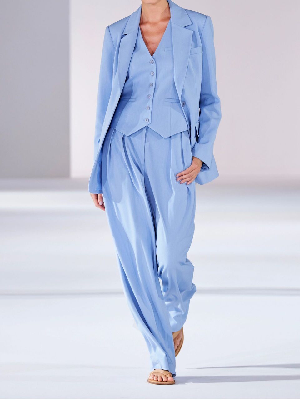 model on catwalk wearing blue staud suit